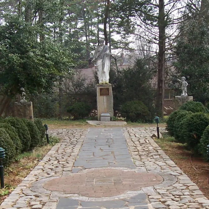 Courts of Justice statue viewed along a stone pathway at MacCallum More Museum & Gardens in Chase City VA