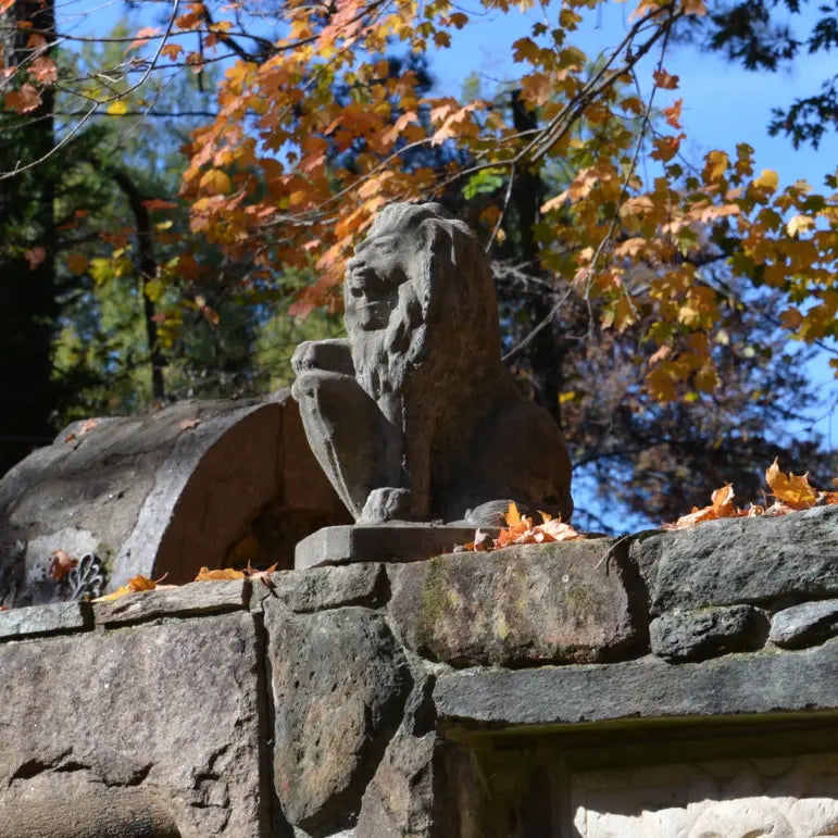 Stone lion sculpture atop the mausoleum wall at MacCallum More Museum & Gardens in Chase City VA